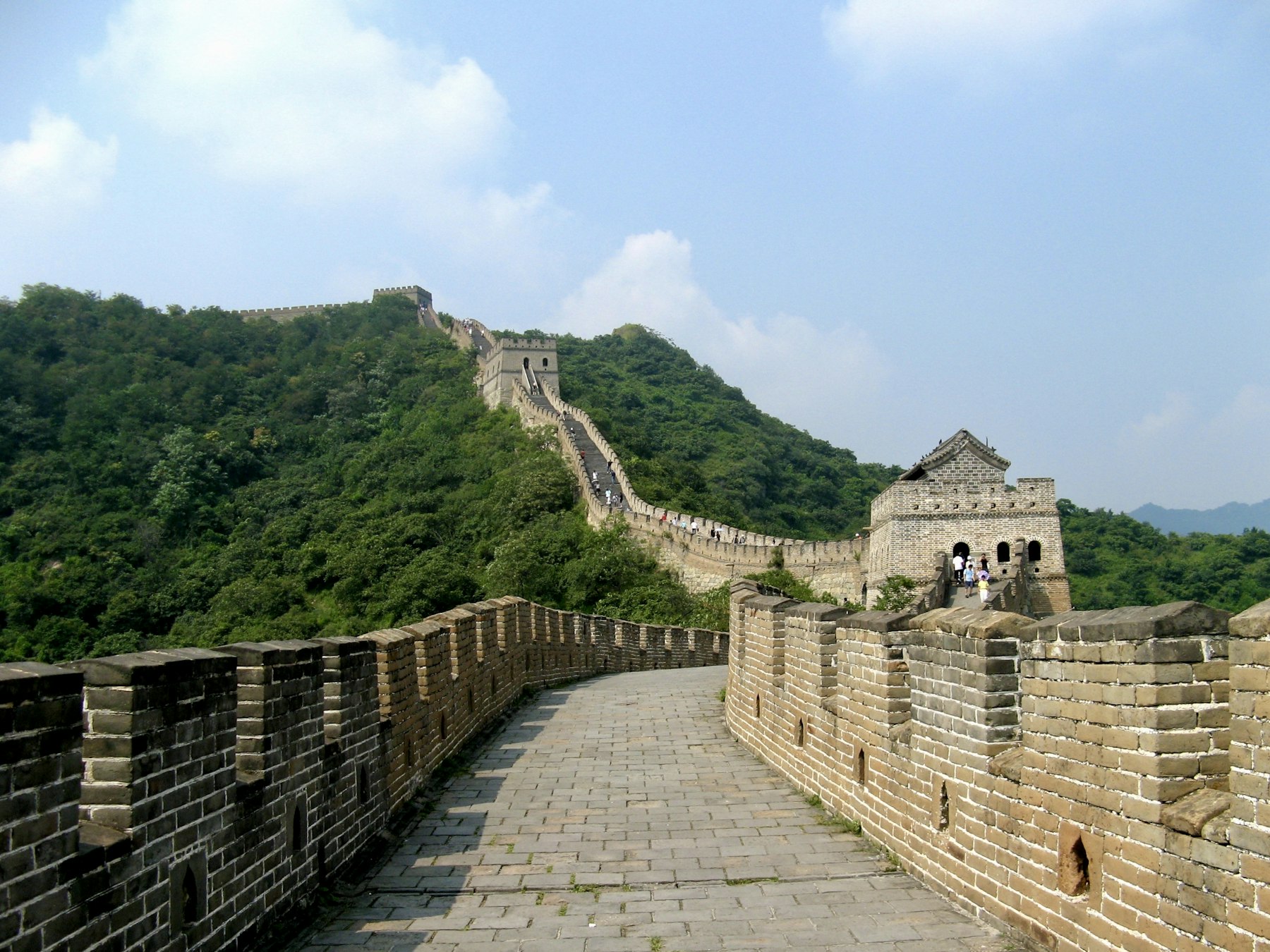 The Great Wall climbing a green ridge at Mutianyu near Beijing