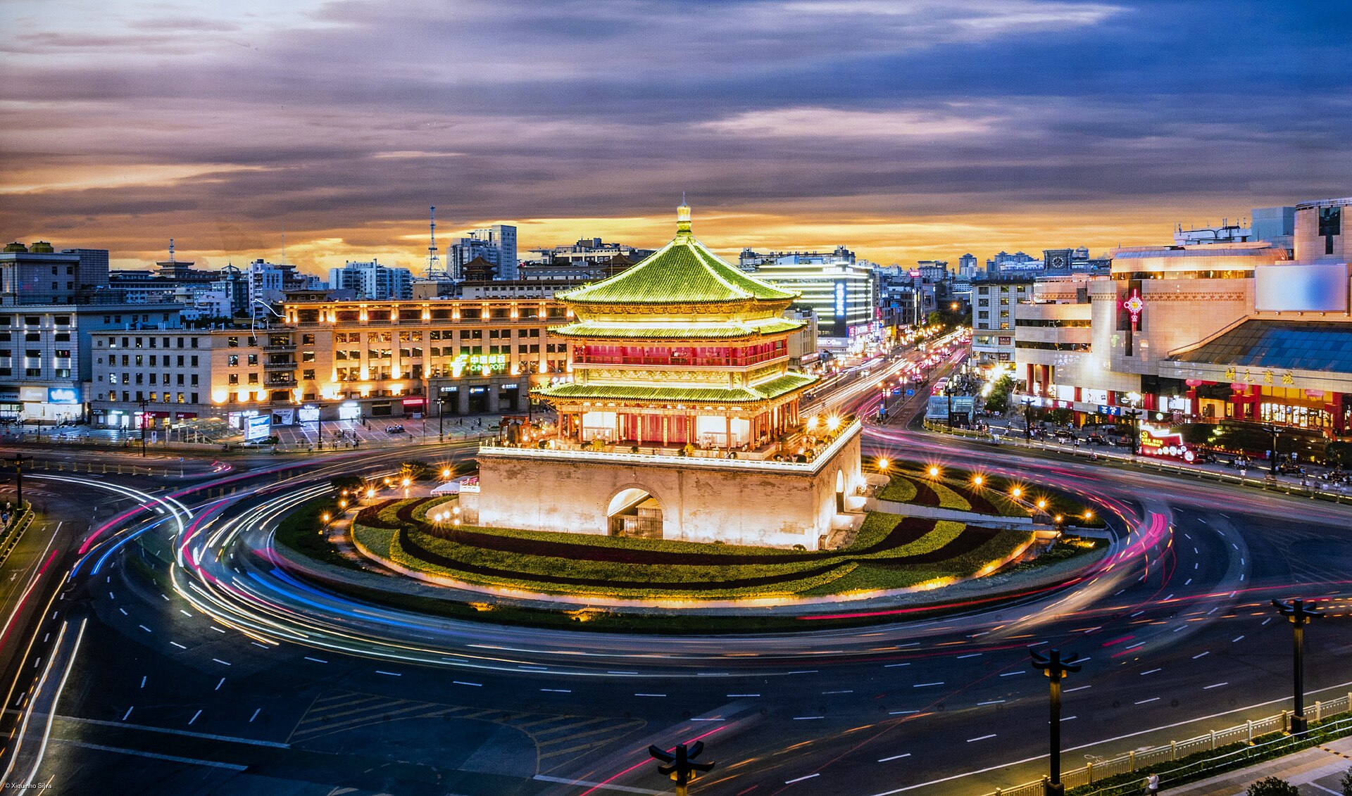 Xi'an Bell Tower glowing at night amid the modern city